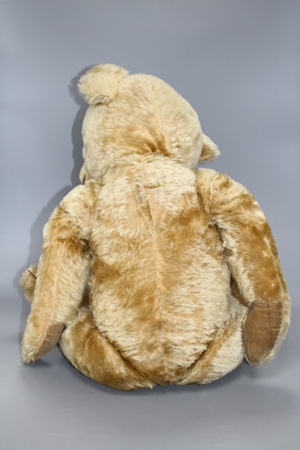 A Chiltern Hugmee 1930s bear, 25in., velvet pads, bald patch back of both legs and also back of neck